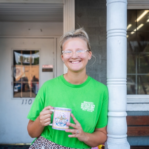 Business owner standing in front of shop