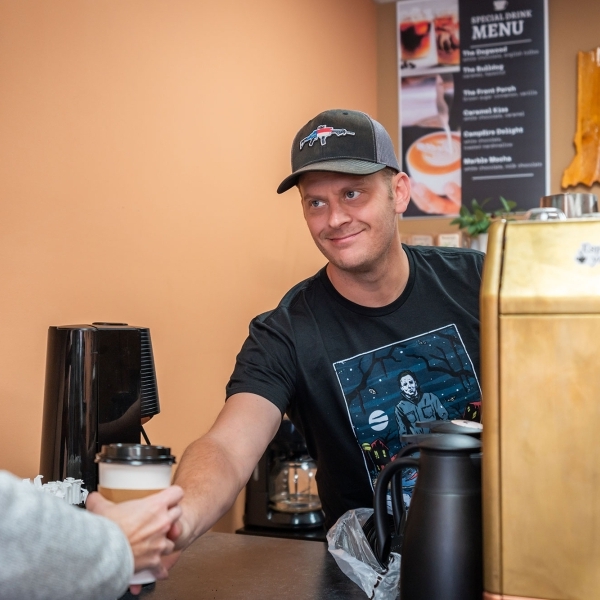 Man buying coffee at shop