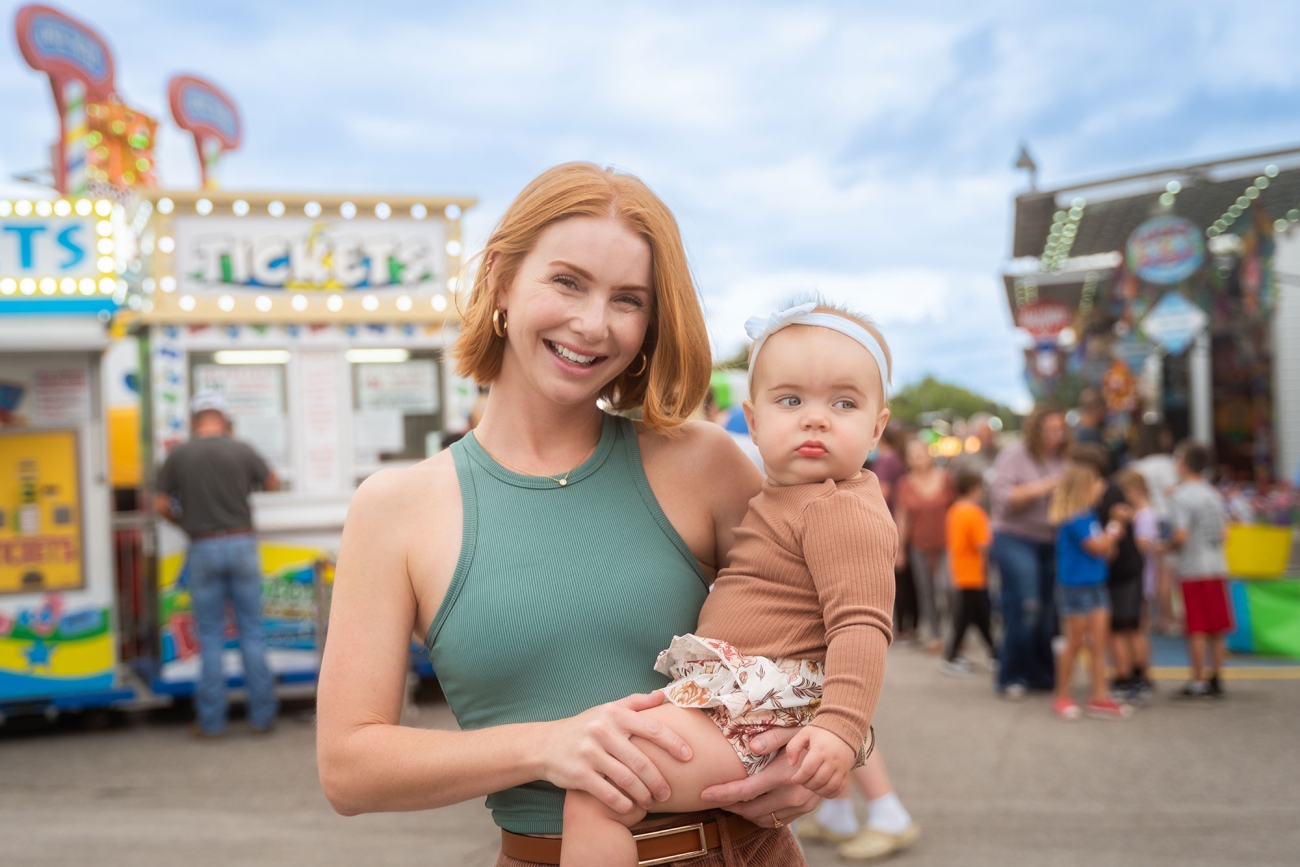 Mother holding baby at fair